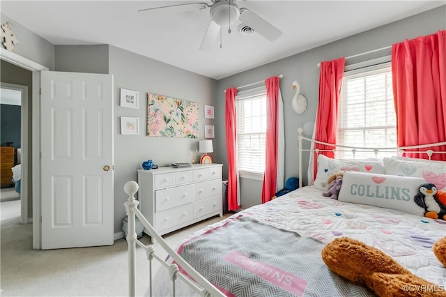 bedroom featuring light carpet and ceiling fan