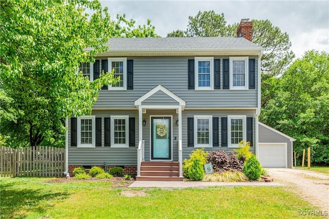 colonial inspired home with a chimney, entry steps, fence, an outdoor structure, and a front yard