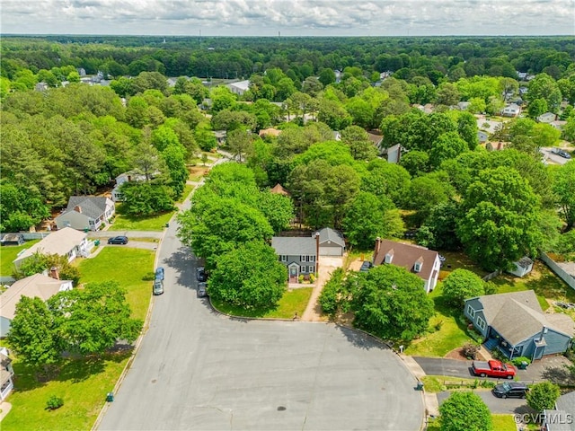 aerial view featuring a forest view and a residential view