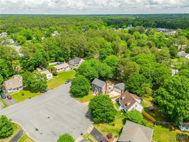 bird's eye view featuring a wooded view and a residential view