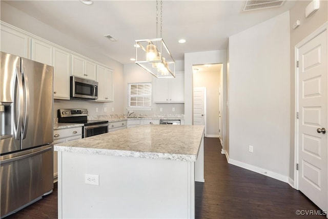 7812 Vermeil St, Chesterfield, VA 23237 - kitchen featuring a center island, white cabinets, visible vents, dark wood-type flooring, and appliances with stainless steel finishes