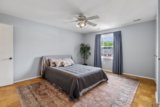 bedroom with baseboards and a ceiling fan
