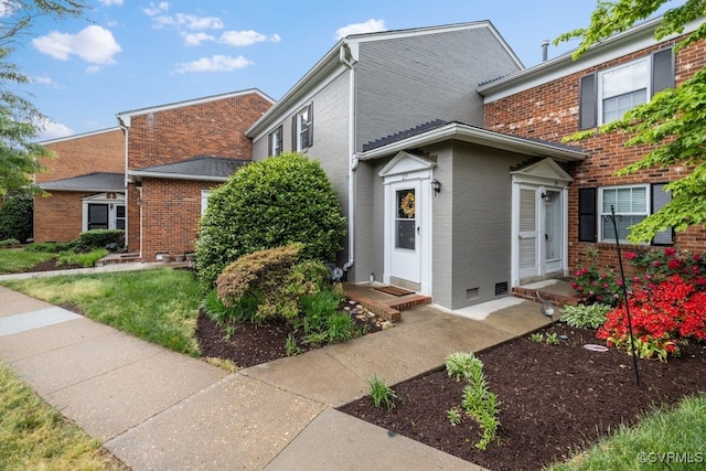 view of front of home featuring brick siding