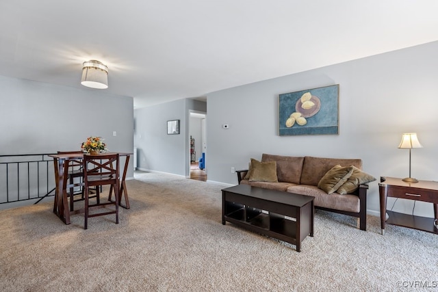 carpeted living room featuring baseboards
