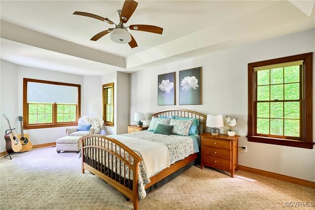 carpeted bedroom featuring baseboards and a ceiling fan