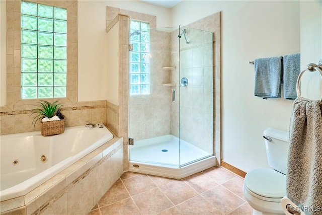 full bath featuring toilet, a shower stall, tile patterned flooring, and a jetted tub