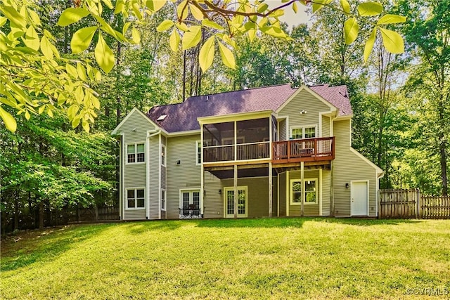 back of house with fence, a deck, french doors, a sunroom, and a yard