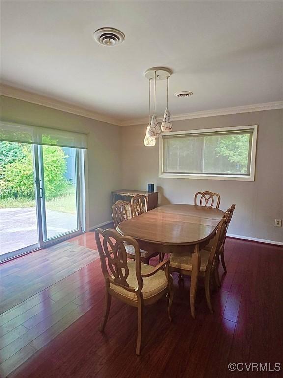 2503 Glendale Ave, Petersburg, VA 23805 - dining area with dark wood finished floors, ornamental molding, and a chandelier