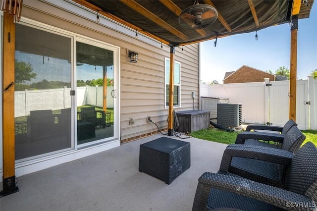 view of patio / terrace featuring central air condition unit, ceiling fan, and fence