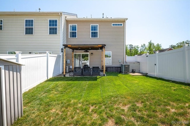 back of house featuring central AC unit, a fenced backyard, and a yard