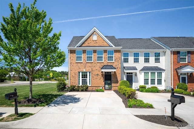 view of front of property with a front lawn and brick siding