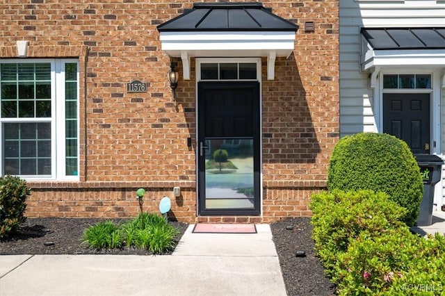 entrance to property with brick siding