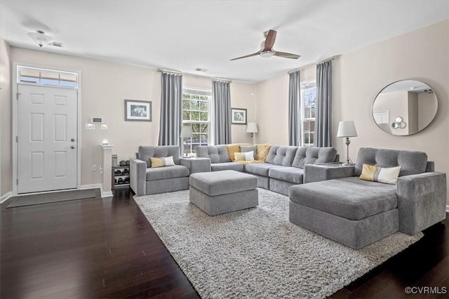 living area featuring ceiling fan, dark wood finished floors, baseboards, and visible vents