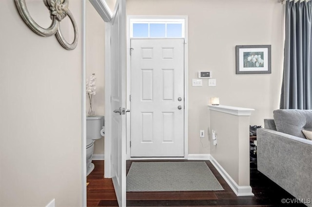 entryway featuring baseboards and dark wood finished floors