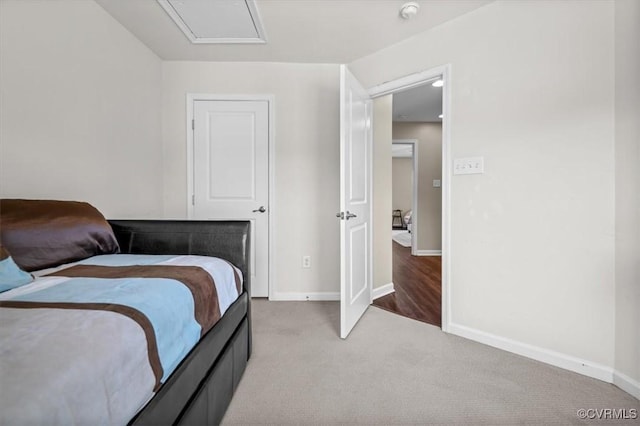 bedroom featuring carpet floors, baseboards, and attic access
