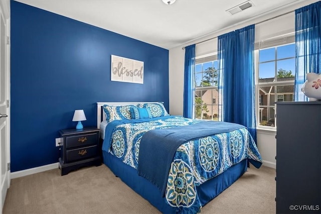 bedroom with carpet floors, baseboards, and visible vents