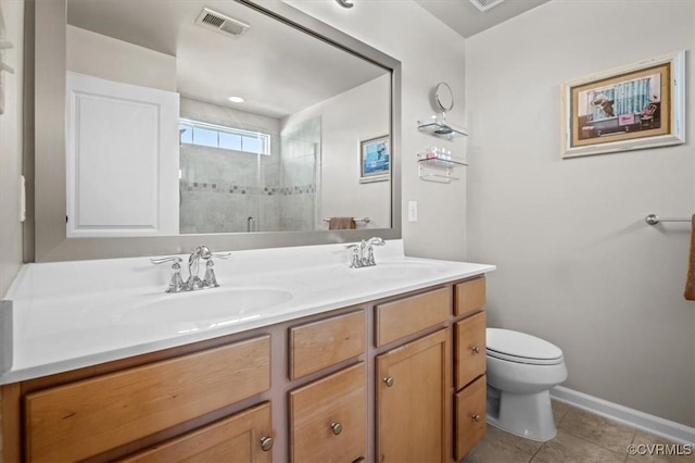 bathroom featuring double vanity, toilet, a shower stall, and a sink