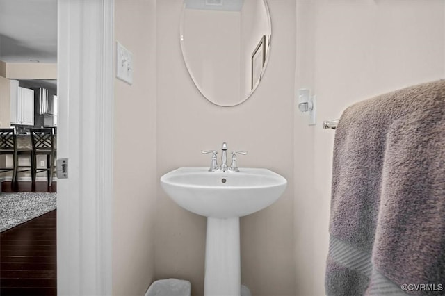 bathroom with a sink and wood finished floors