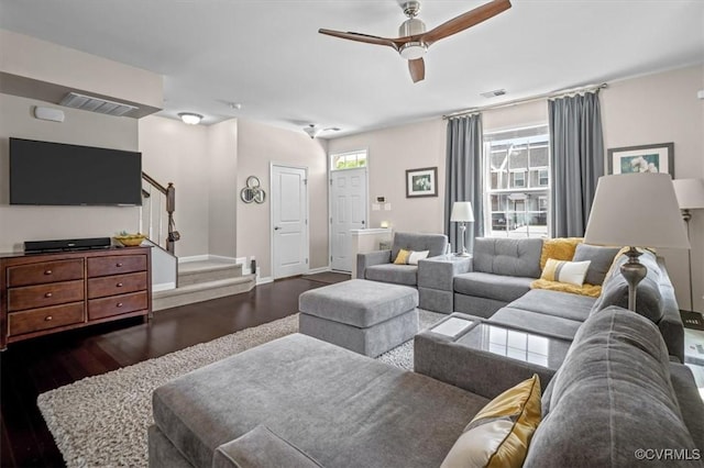 living area with ceiling fan, visible vents, wood finished floors, stairway, and baseboards