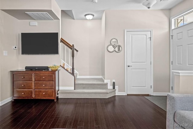 foyer featuring stairway, baseboards, hardwood / wood-style flooring, and visible vents