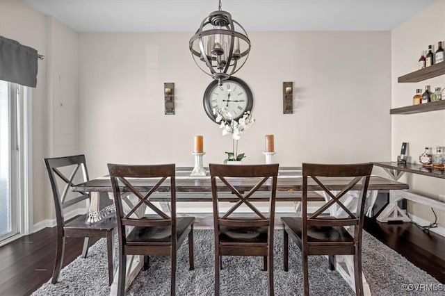 dining space with an inviting chandelier, baseboards, wood finished floors, and a wealth of natural light