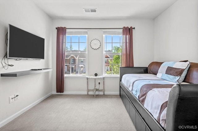 carpeted bedroom featuring baseboards and visible vents