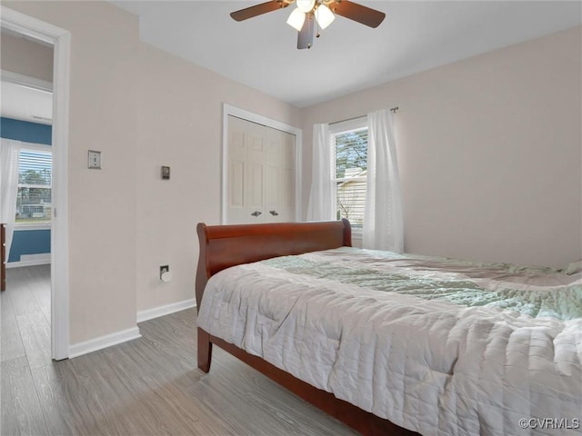 239 Marine Dr, Dunnsville, VA 22454 - bedroom featuring multiple windows, wood finished floors, and baseboards