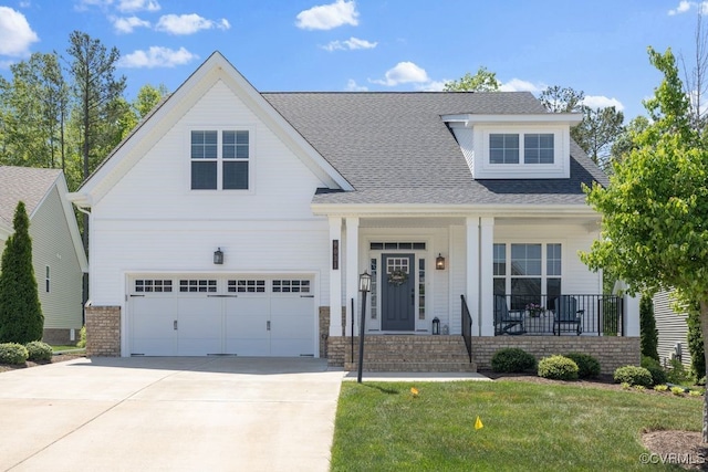 view of front of property with roof with shingles, a garage, a front yard, concrete driveway, and covered porch