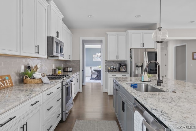 kitchen with a sink, white cabinetry, dark wood finished floors, and stainless steel appliances