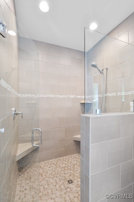 bathroom with recessed lighting and a tile shower