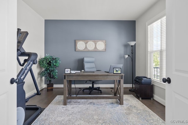 office space with baseboards and wood finished floors