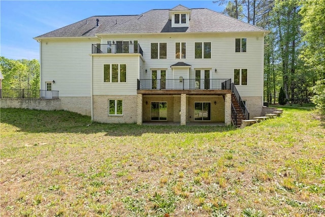 back of house featuring a lawn, fence, stairs, and a wooden deck