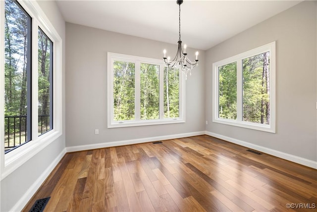 interior space with plenty of natural light, baseboards, and visible vents