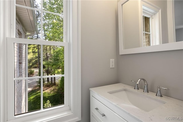 bathroom featuring plenty of natural light and vanity