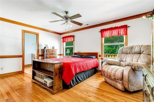 bedroom with crown molding, visible vents, wood finished floors, baseboards, and a ceiling fan
