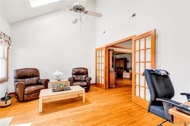 interior space with visible vents, high vaulted ceiling, light wood-type flooring, french doors, and a ceiling fan