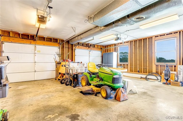 garage featuring visible vents and a garage door opener