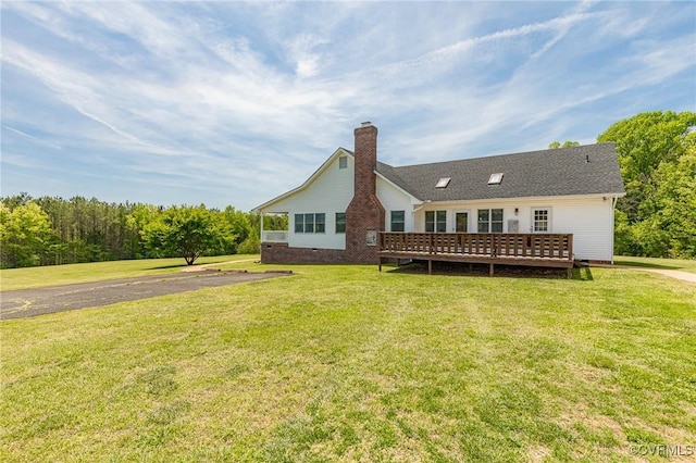 rear view of house featuring a yard, crawl space, a chimney, and a wooden deck