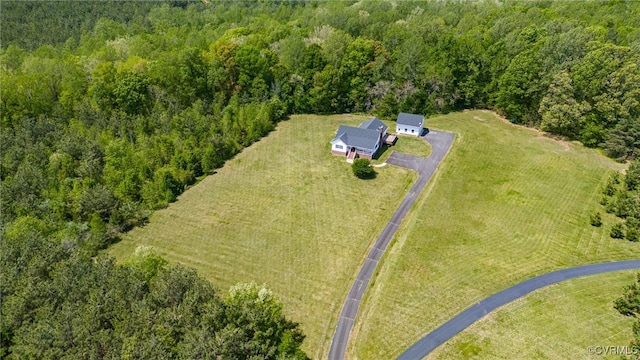 birds eye view of property featuring a wooded view