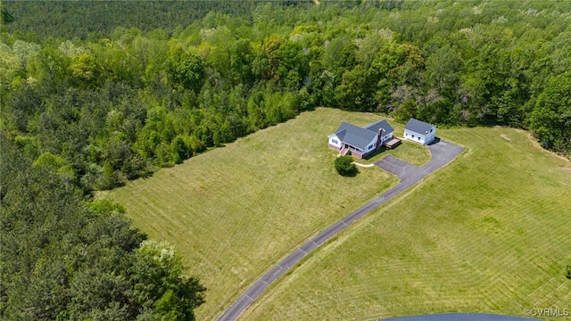 drone / aerial view featuring a forest view