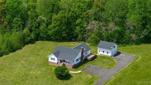 birds eye view of property with a wooded view