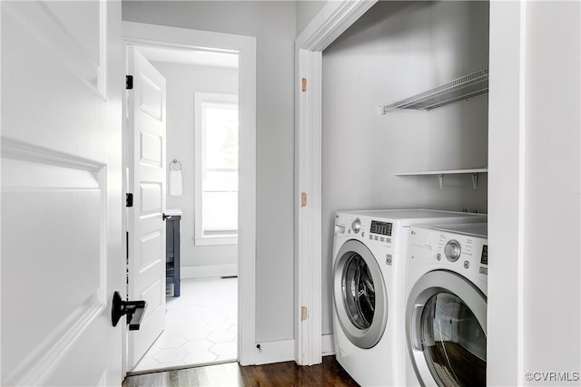 laundry room with laundry area, dark wood finished floors, baseboards, and washer and dryer