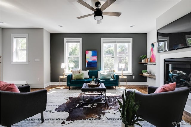 living room with baseboards, wood finished floors, and a wealth of natural light