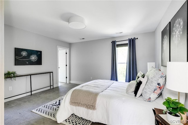 bedroom with baseboards and visible vents