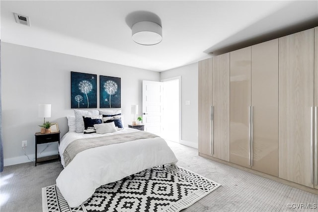 bedroom with visible vents, baseboards, and light colored carpet