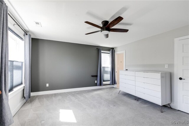 unfurnished bedroom with visible vents, a ceiling fan, carpet, and baseboards