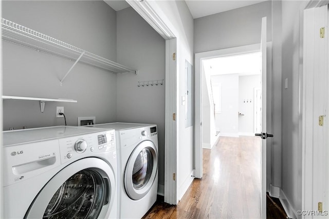washroom with laundry area, dark wood-style flooring, baseboards, and washing machine and clothes dryer