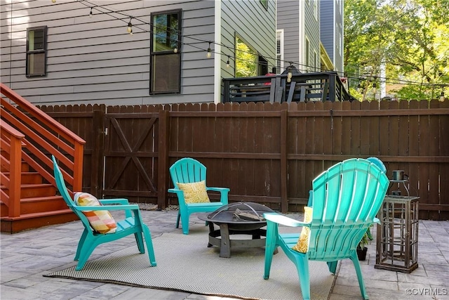 view of patio with fence and an outdoor fire pit