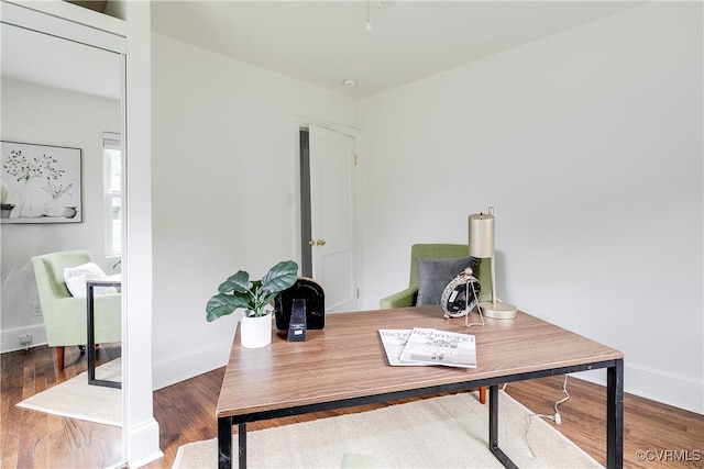office space featuring baseboards and wood finished floors