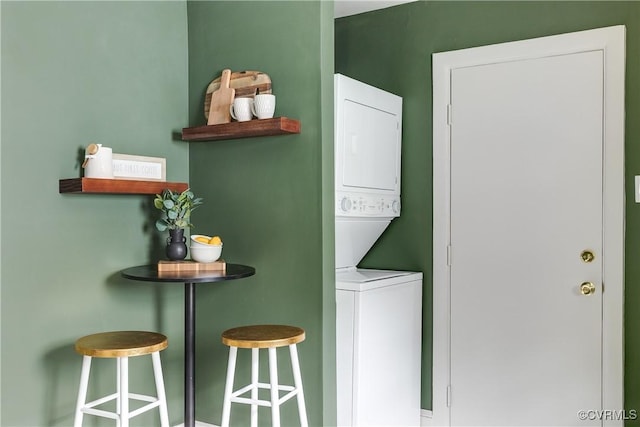 laundry area with stacked washer and clothes dryer and laundry area